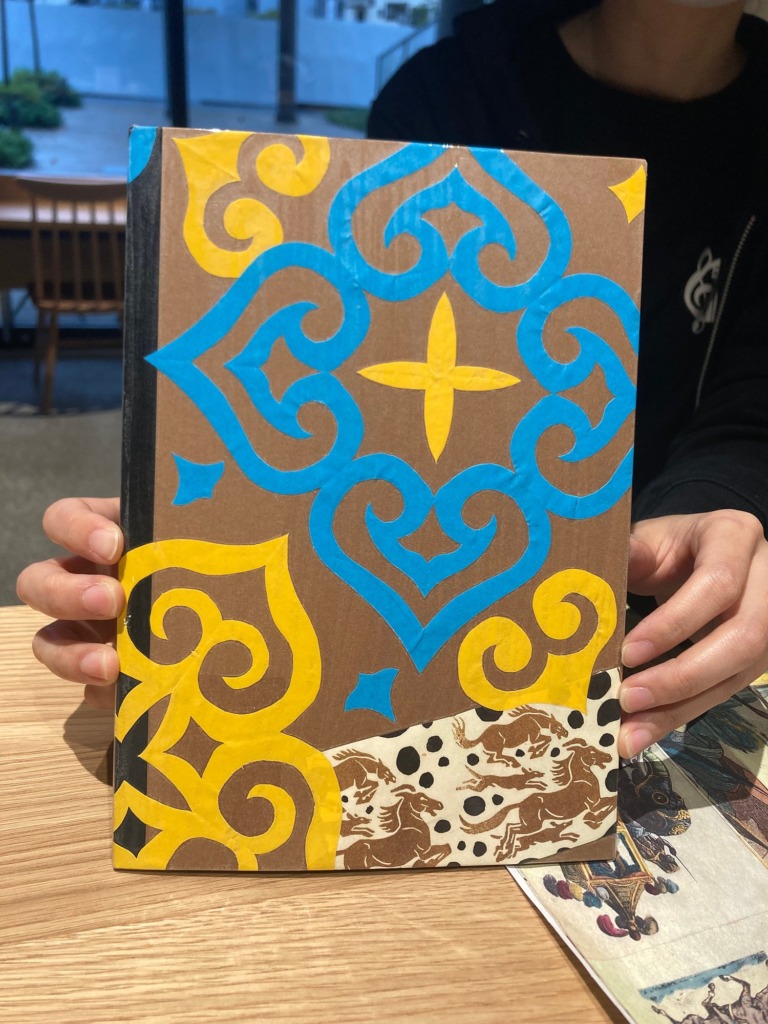 Notebook cover decorated with a cut-paper Ainu pattern