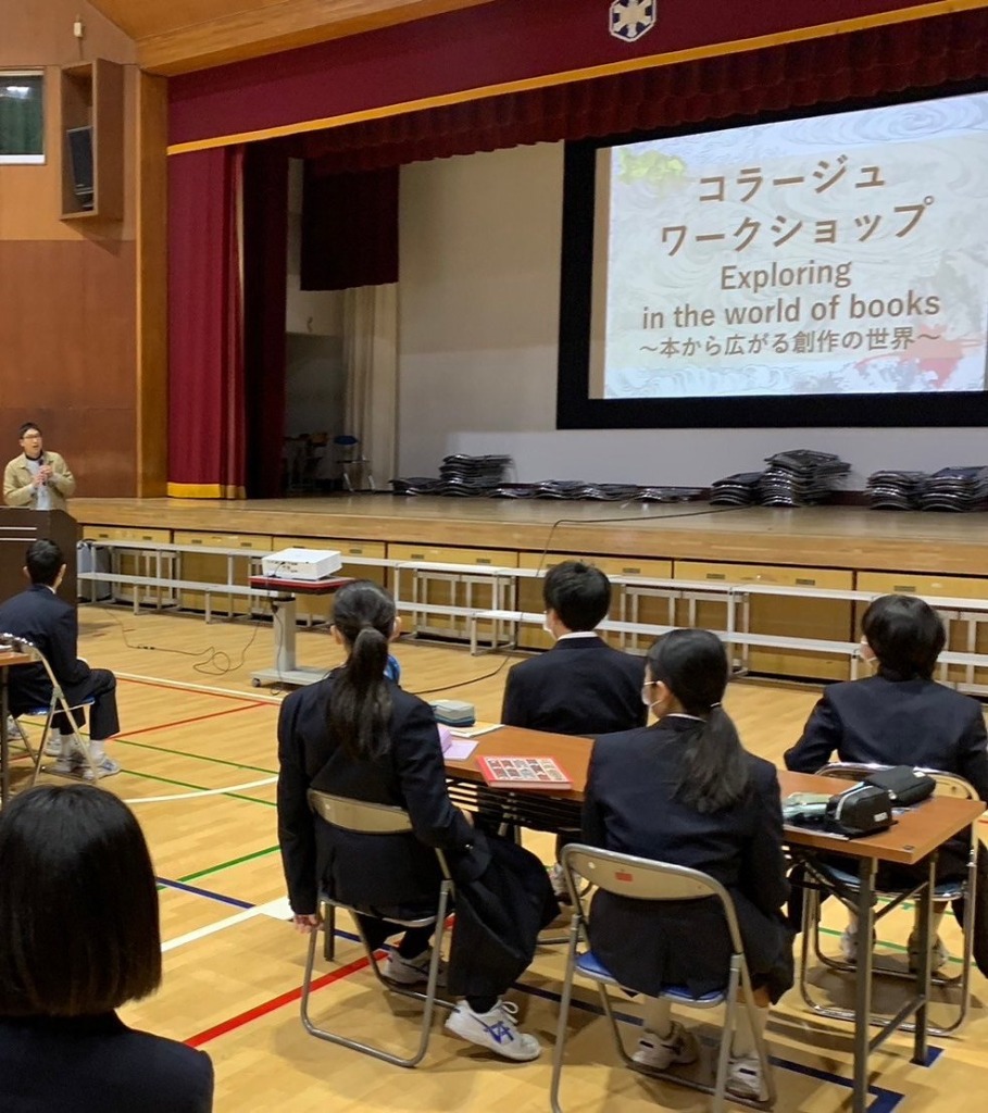 Kisho Matsuo giving a talk in a school gym, with the workshop title on the screen