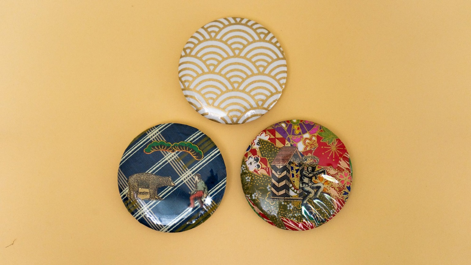 Three collage button badges made from Japanese patterns and old illustrations